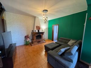 a living room with a couch and a fireplace at Residenza Pozzillo in Cinisi