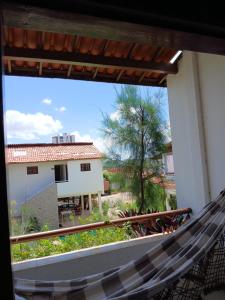 a hammock on the balcony of a house at Pousada Vila Verde in Juazeiro do Norte