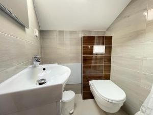 a bathroom with a white sink and a toilet at Villa Karla in Novalja