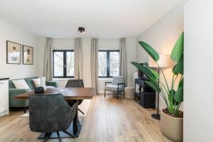 a living room with a table and a dining room at UtrechtCityApartments – Weerdsingel in Utrecht
