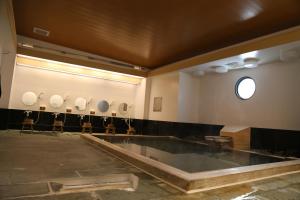 a bathroom with a large pool in the middle of a room at Hotel Plaza Arakawaoki in Tsuchiura