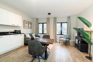 a kitchen and living room with a table and chairs at UtrechtCityApartments – Weerdsingel in Utrecht