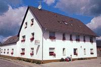 a large white building with a brown roof at Hotel-Pension Märkischheide in Vetschau