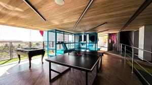 Una sala de estar con una mesa de ping pong. en New Time Paju 1110, en Maceió