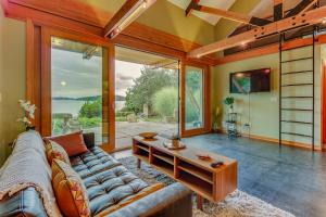 a living room with a couch and a table at Driftwood Retreat in Anacortes