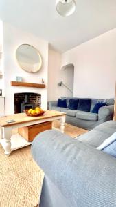 a living room with a couch and a table at Seascape Luxury Cottage Southwold - Free Parking in Reydon