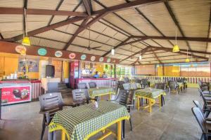 a dining room with tables and chairs and a restaurant at Roseal Beach Front in Baga