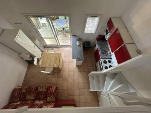an overhead view of a small kitchen with a stove at G1 Manadiers T3 parking piscine terrasse in Saintes-Maries-de-la-Mer +3 photos