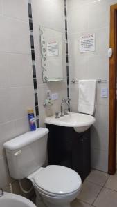 a bathroom with a white toilet and a sink at Los ciruelos mar de cobo in Mar de Cobo +13 photos