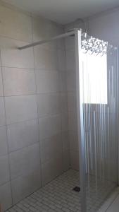 a shower with a glass door in a bathroom at CHALET AU CALME à GERARDMER in Gérardmer +23 photos