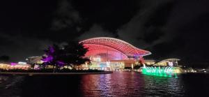 a building lit up at night with lights in the water at Stay practico y moderno en Carolina cerca de la zona turística de Isla Verde in Carolina +15 photos
