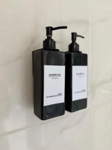 two bottles of soap sitting on a shelf at L’Oliveraie in Lille