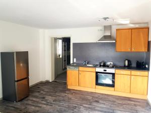 a kitchen with wooden cabinets and a stove at Apartment Bad Salzschlirf in Bad Salzschlirf
