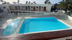 a swimming pool in front of a house at Solarena - Sol44 in Maspalomas