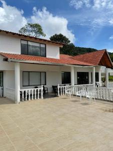 a building with a lot of chairs in front of it at Hotel y Restaurante la Florida in Páramo