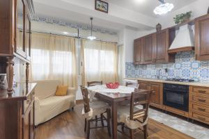 kuchnia ze stołem, krzesłami i kanapą w obiekcie Gmg - Mondello House w mieście Palermo