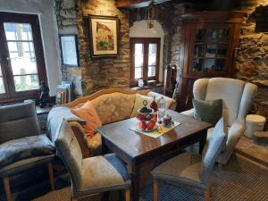 a living room with a couch and a table and chairs at Alter Spieker Sundern-Endorf in Endorf