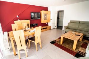 a living room with a table and a couch at Duhner Ausblick mit Balkon in Cuxhaven +20 photos