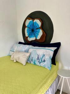 a room with a bed with a flower on the wall at Suíte 1 - Village Capixaba in Gravatá