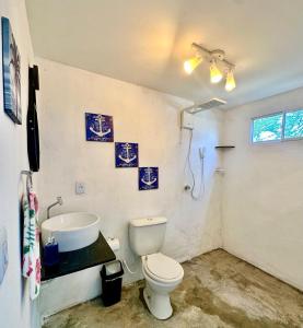 a bathroom with a toilet and a sink at Suíte 1 - Village Capixaba in Gravatá +12 photos