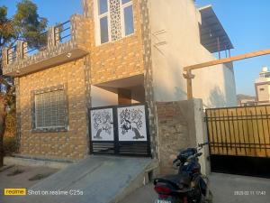 a motorcycle parked in front of a house at Sukoon - The Bliss in Udaipur
