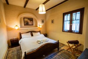 a bedroom with a bed with two books on it at Fanaras Hotel in Kalavrita