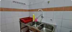 a kitchen sink with a faucet and a red basket at KK Minimalist Budget 2 Bedroom Appt f 6 free park in Penampang