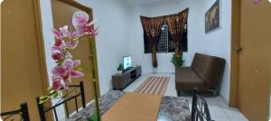 a living room with a table and a chair at KK Minimalist Budget 2 Bedroom Appt f 6 free park in Penampang
