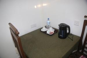 a table in a room with a coffee maker on it at Evergreen Cottage in Ella