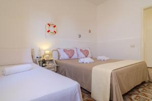 Posteľ alebo postele v izbe v ubytovaní Villa Grecale Porto Cesareo