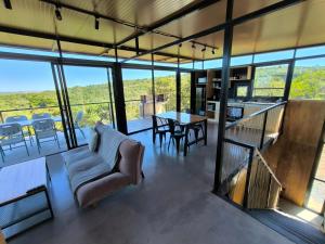 a living room with a couch and a table at Villa Toscana II - Excelentes Vistas y Confort in Villa Serrana +31 photos