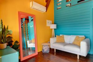 a living room with a couch and a mirror at Quinta da Estrela in Ponte Nova