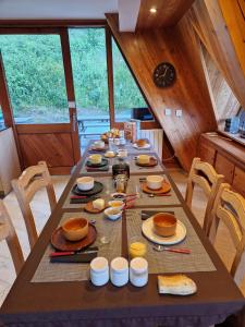 a table with plates of food on top of it at le chalet pointu de capucine in Bourg-Saint-Maurice