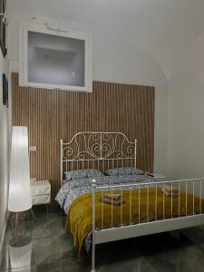 a bedroom with a bed and a wall at San Carlo 104 in Caserta +20 photos