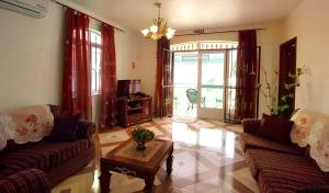 a living room with two couches and a coffee table at Rama Villas Mauritius in Trou aux Biches