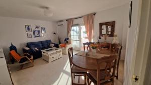 a living room with a table and chairs and a couch at Beautiful apartment in Calahonda beach in Sitio de Calahonda
