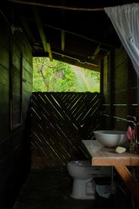 a bathroom with a sink and a toilet at Casa Cielito in Nuquí