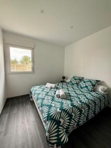 a bedroom with a bed and a window at Les gîtes Pléhédelais TER in Pléhédel +27 photos