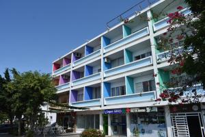 an apartment building with colorful balconies on a street at Panamerican Hostel in Santa Marta