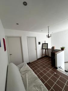 een woonkamer met een bank en 2 deuren bij Casa Barracas, habitación privada in Buenos Aires