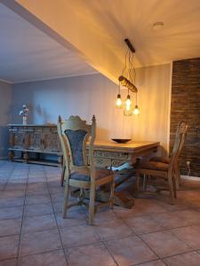 a dining room with a wooden table and chairs at Ferienhaus Schwanensee in Senftenberg