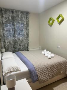 a bedroom with a bed with towels on it at Family Relax Salou in Salou +19 photos