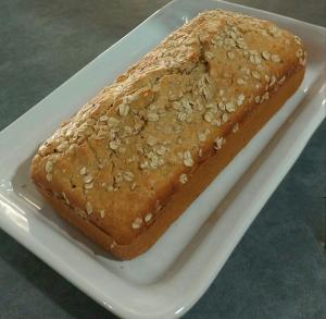 a piece of bread with nuts on a white plate at NC Hotel in Bragança Paulista