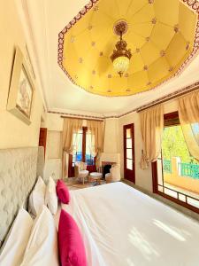 a bedroom with a large bed and a chandelier at VILLA 34 - 4 Masters, Moroccan Charm & Modern Comfort with Private Pool in Marrakesh +73 photos