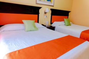 Postel nebo postele na pokoji v ubytování Hotel Las Hamacas