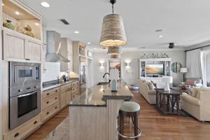 a kitchen and living room with a large island in the middle at WaterHouse 402 in Inlet Beach