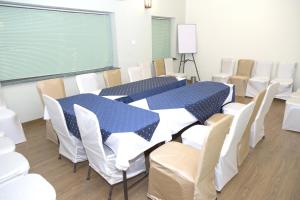 a conference room with a blue table and chairs at 66 Residencey in Jaipur