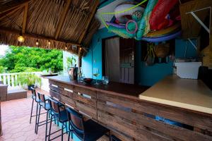 a bar with blue walls and blue stools at Casa Leonore II in Willemstad
