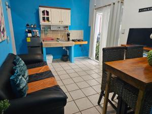 a kitchen and dining room with a couch and a table at LOS SAUCES STUDIO in Puerto Vallarta +7 photos