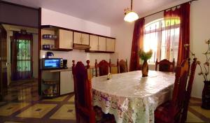 a room with a table and a kitchen with a tv at Rama Villas Mauritius in Trou aux Biches